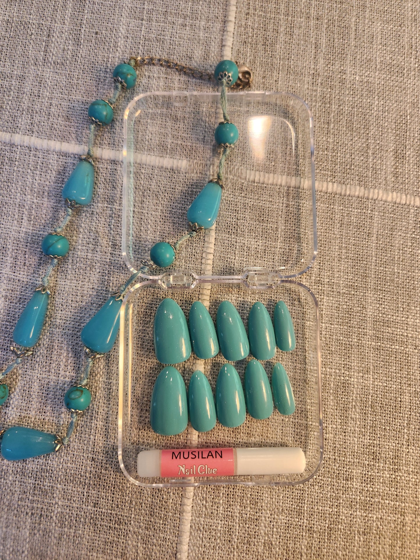 Teal nails with matching teal necklace