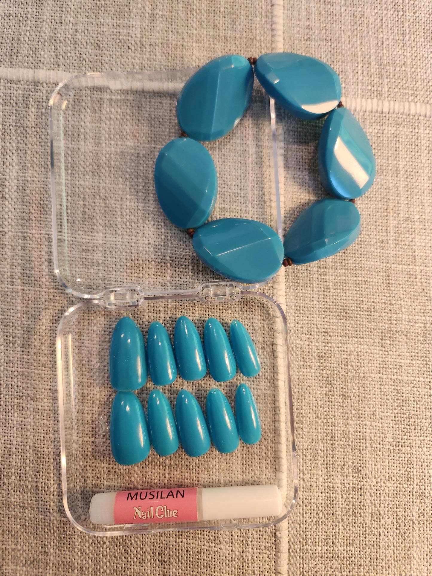 Teal nails with matching teal bracelet