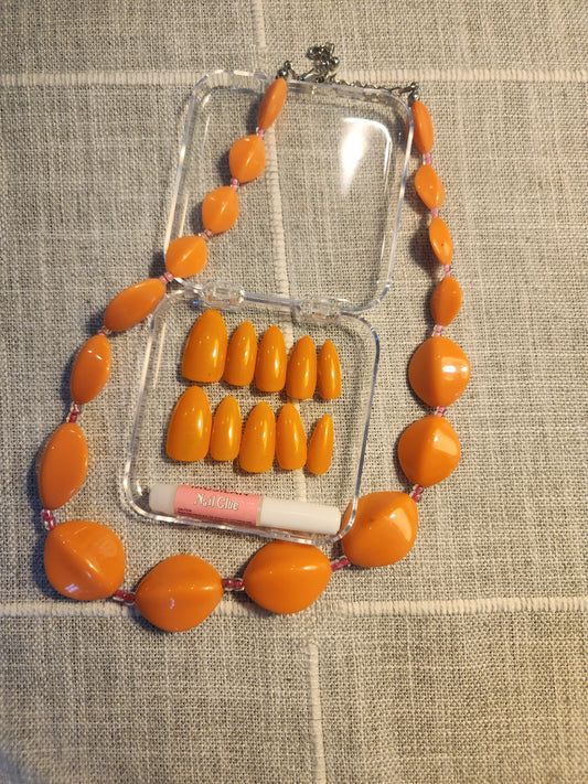 Orange nails with matching orange necklace